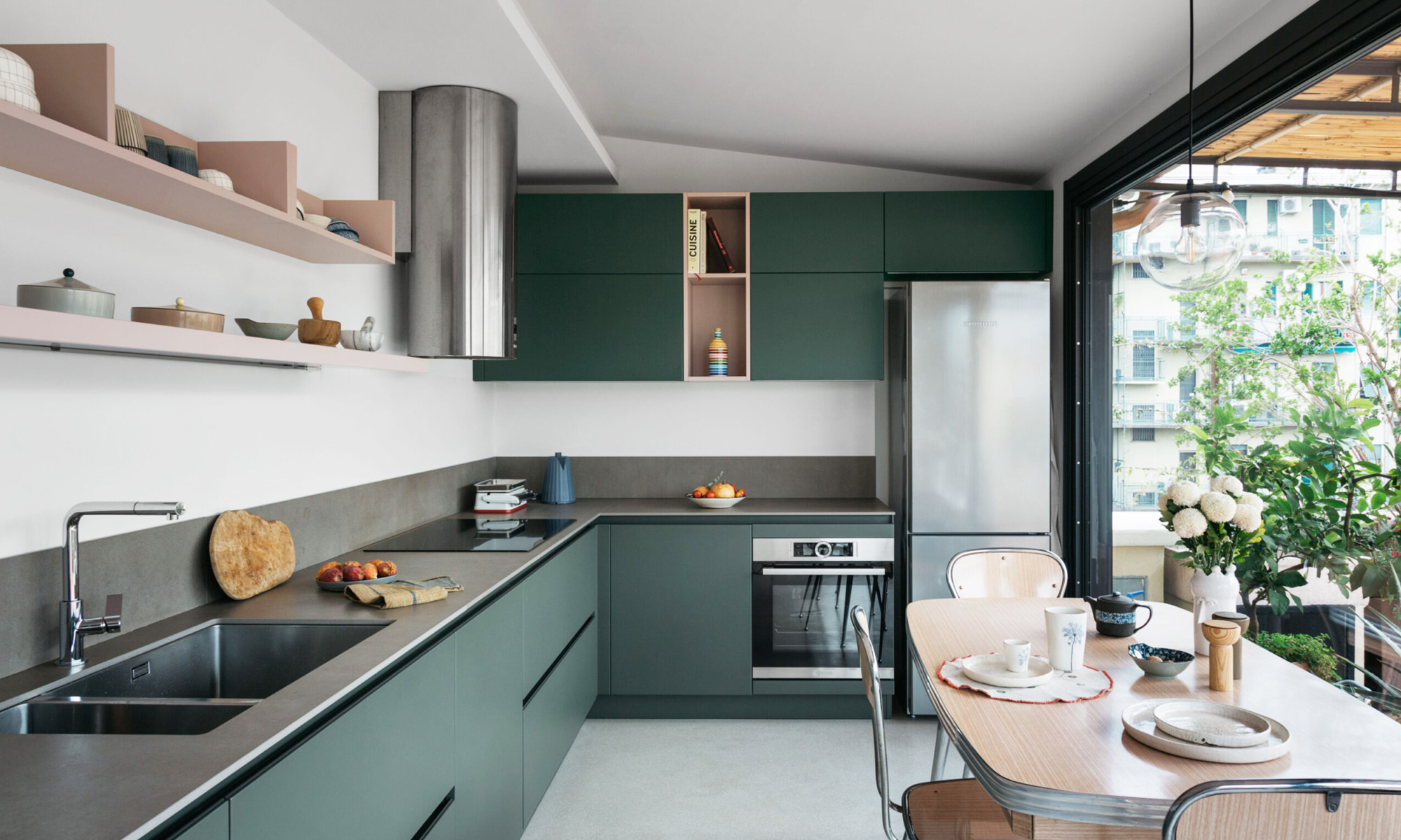 Modern green kitchen by Eutropia Architettura