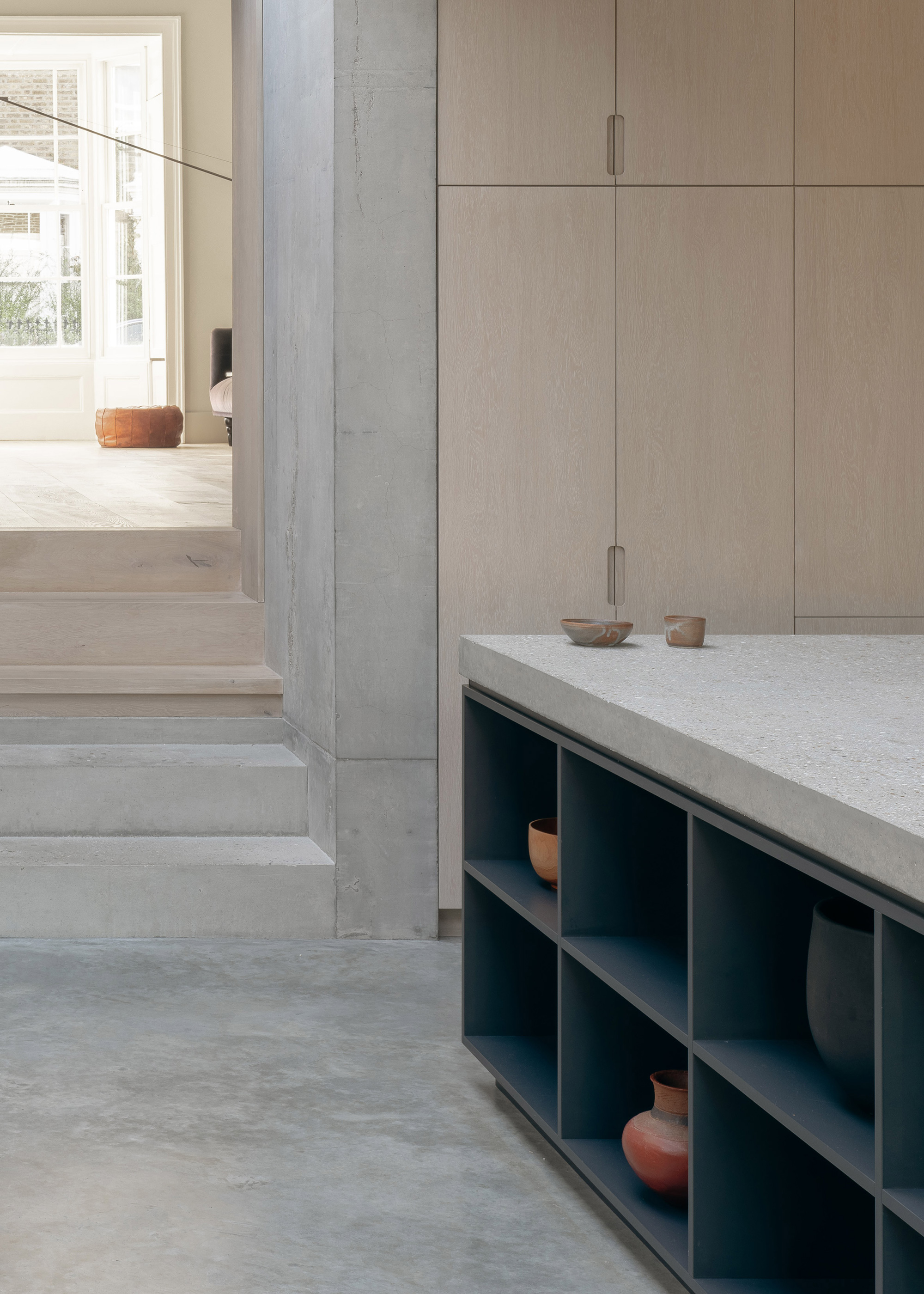 Concrete Plinth House by DGN Studio, dark grey kitchen cabinet 