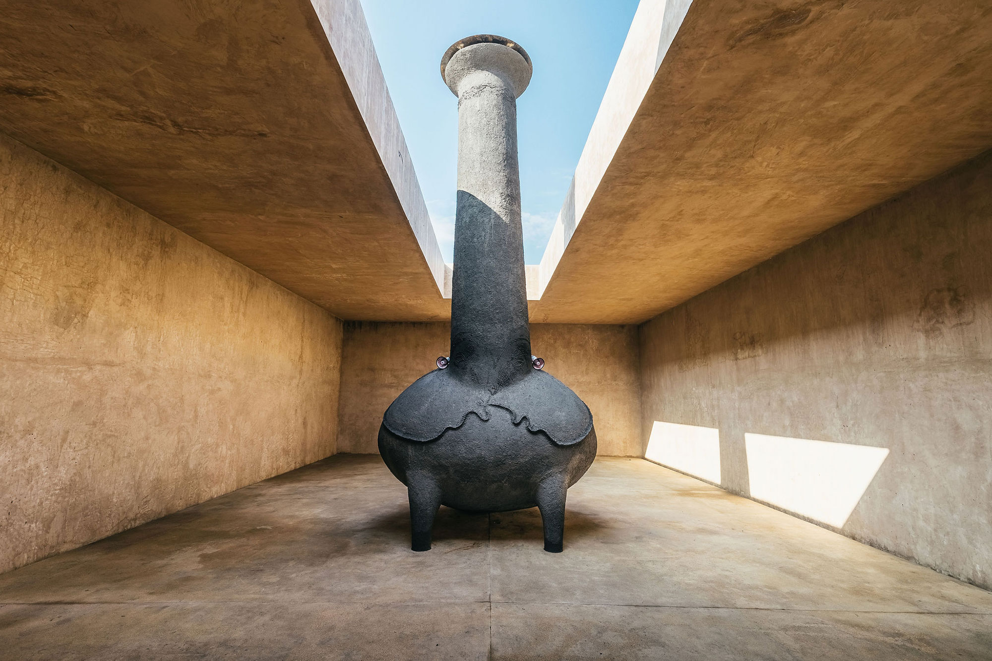 A monolithic sculpture installed in an open-air atrium - Gessato